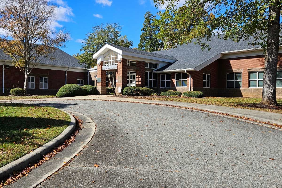 Red brick treatment center with covered entrance and curved driveway