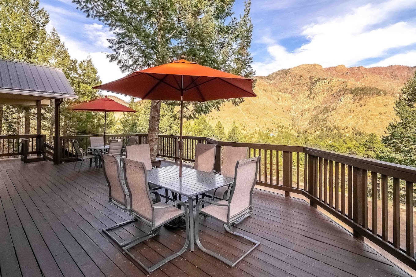 Deck with outdoor dining tables, umbrellas and seats.