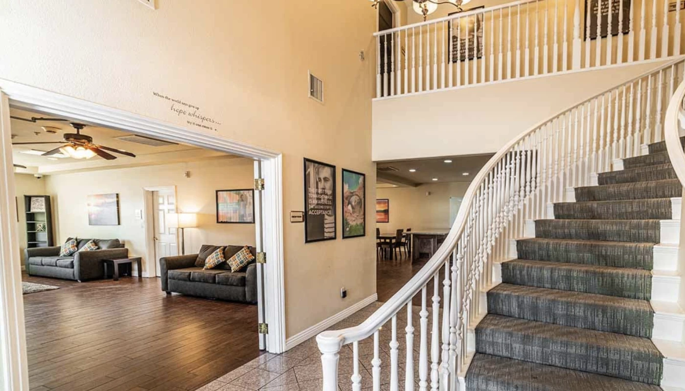 Grand staircase and open lounge with framed wall art