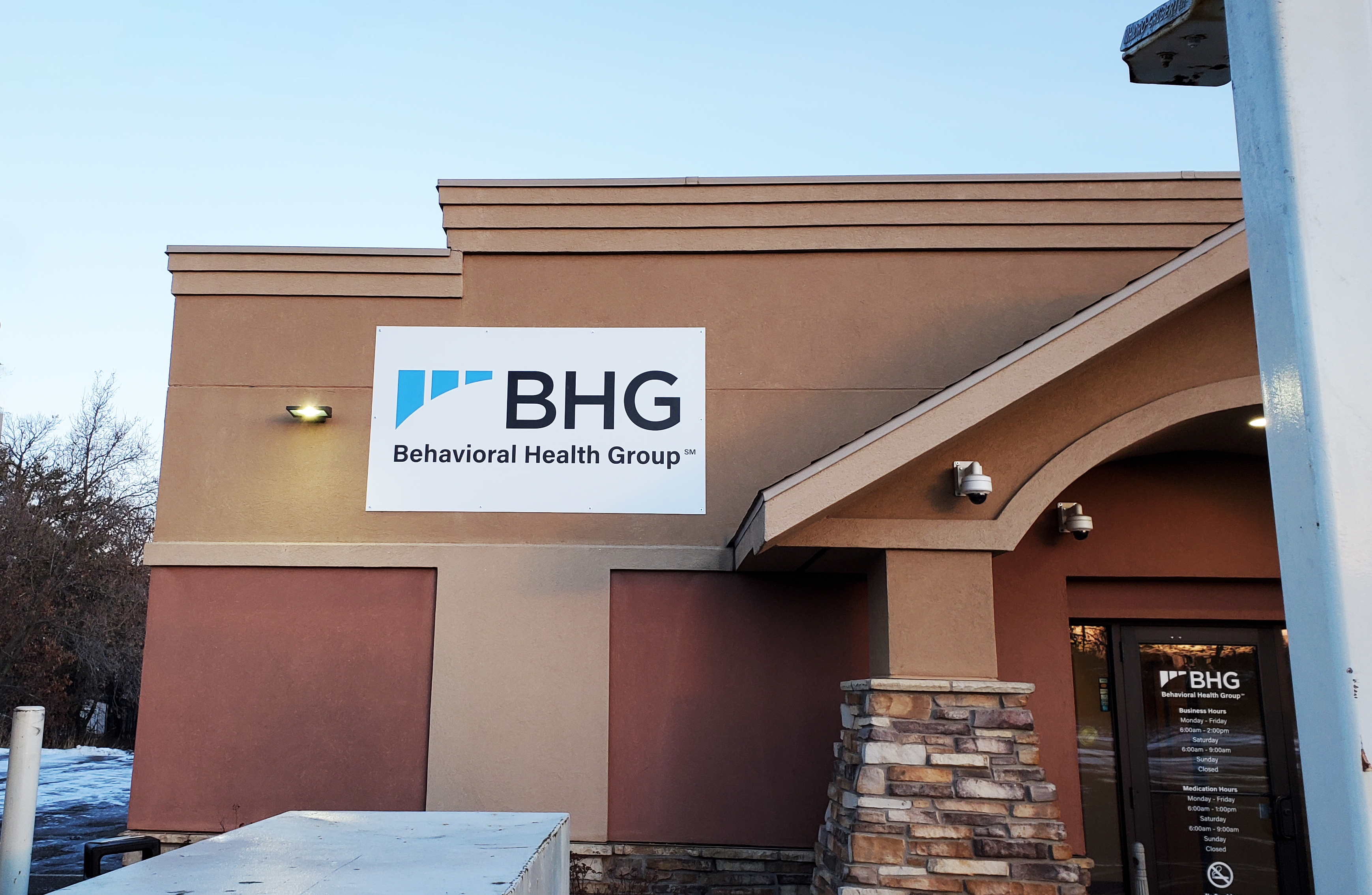 Exterior entrance with BHG building sign above doorway