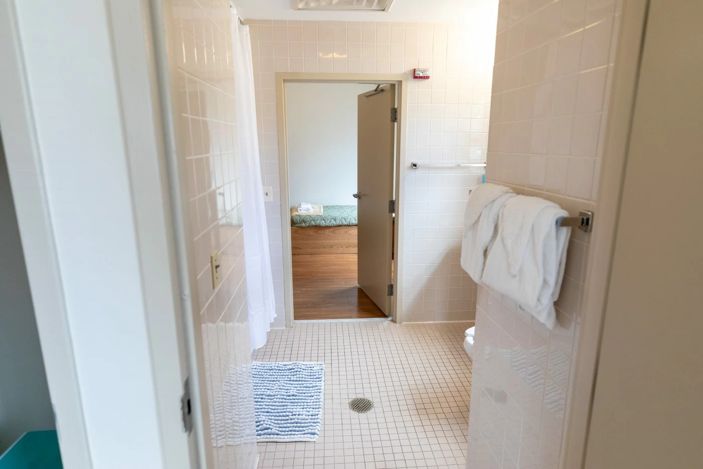 Shared bathroom with shower and towels