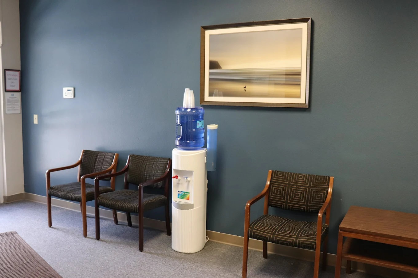 Chairs and water cooler in small lobby seating area