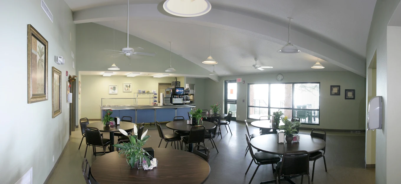 Cafeteria with round tables and food service counter