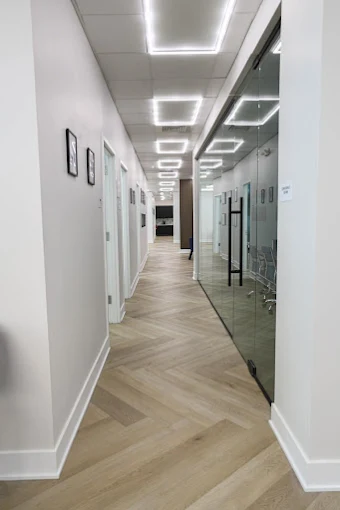 Bright hallway with modern lighting and glass wall