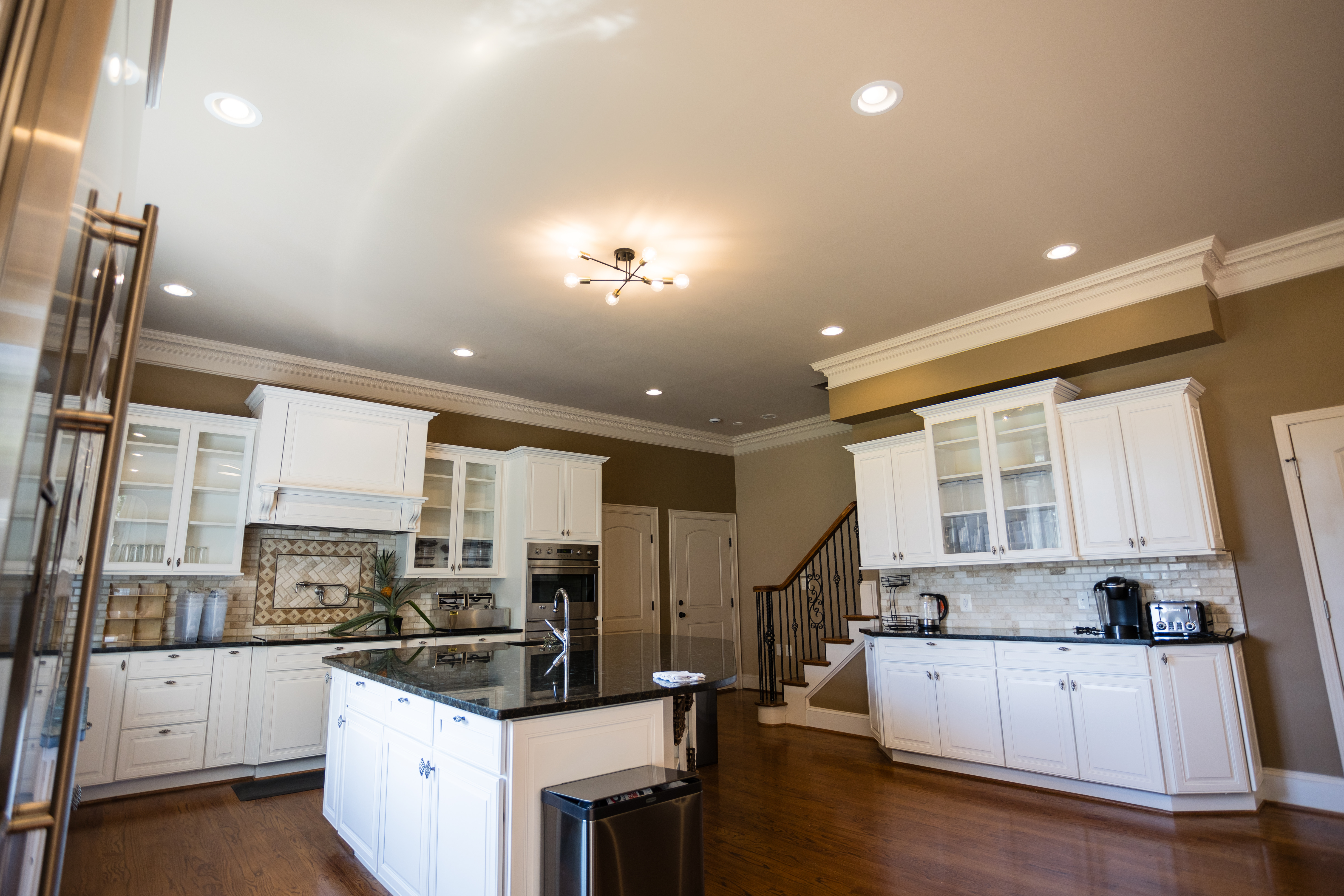 Rehab kitchen with white cabinets and large island