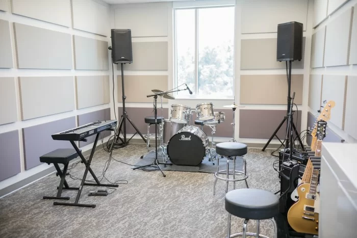 Music therapy room with drums, keyboard, and guitars