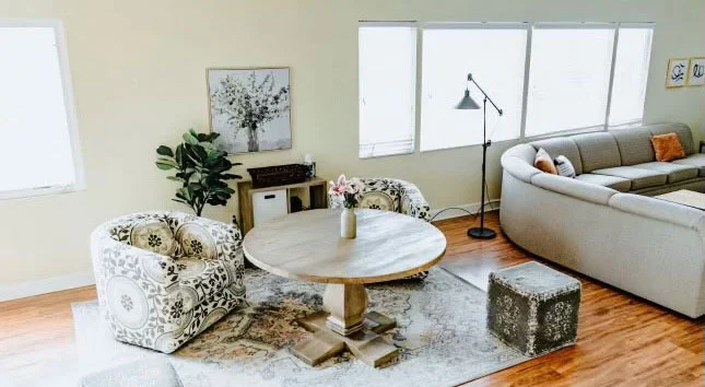 Cozy lounge with patterned chairs and round wooden table