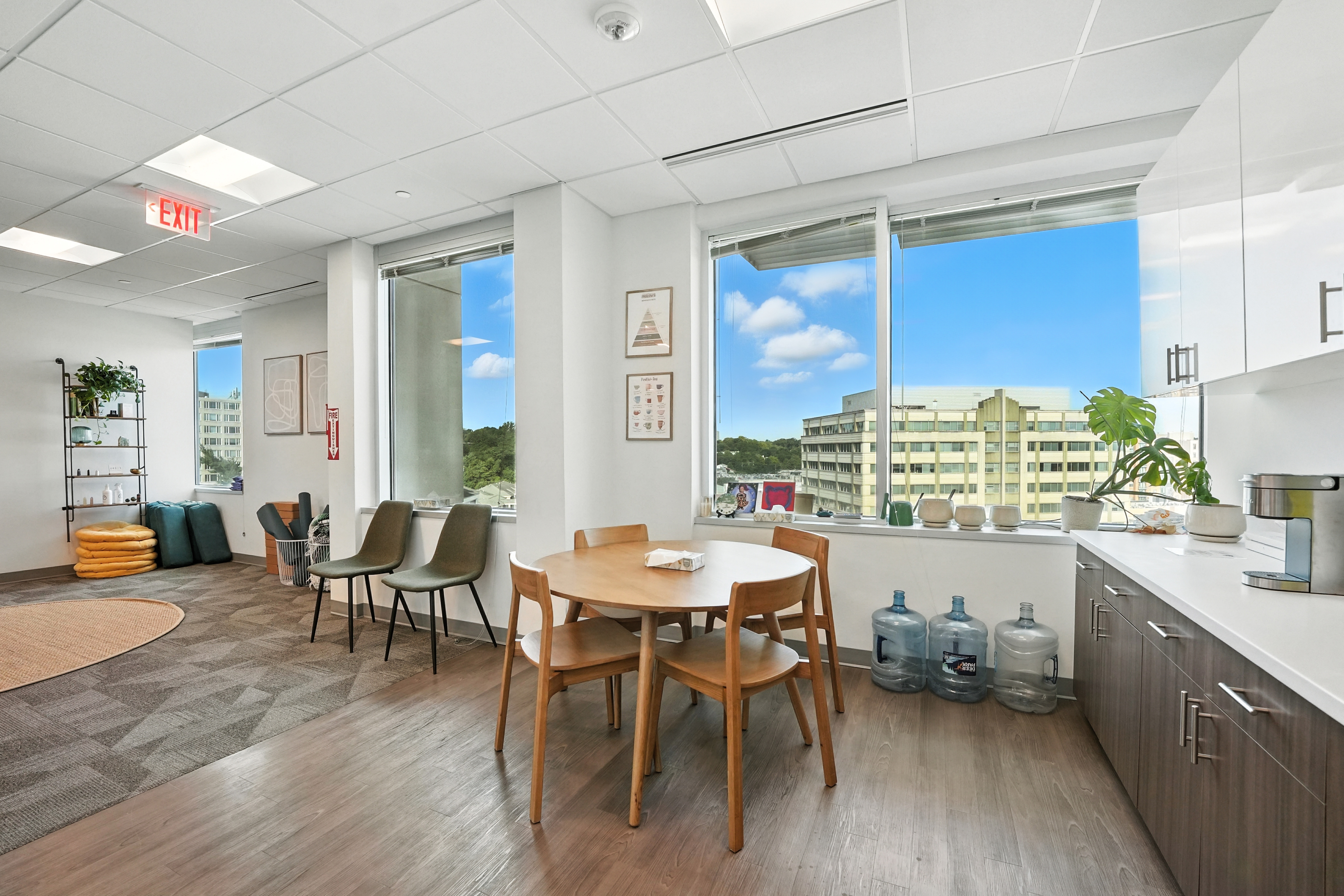 Kitchenette with table, cabinets, and large windows