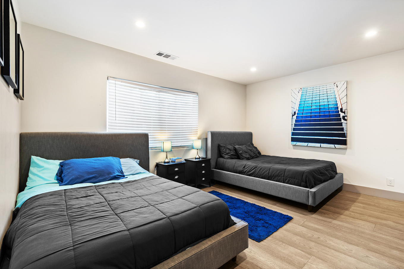 Two beds in shared room with natural light