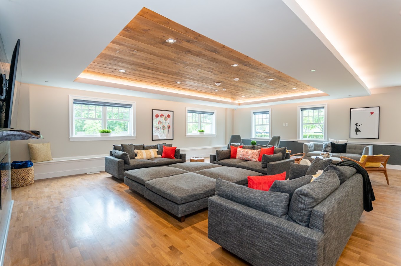  Another angle of the common living space, showcasing stylish sofas, decorative pillows, and framed artwork on the walls.