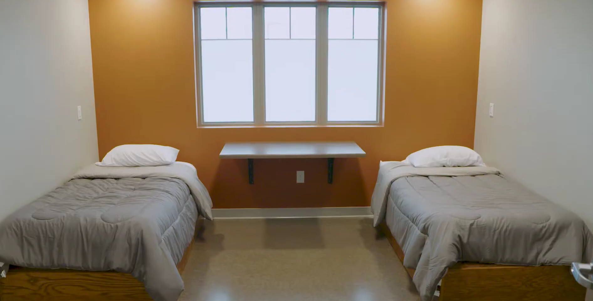 Shared bedroom with two twin beds and window