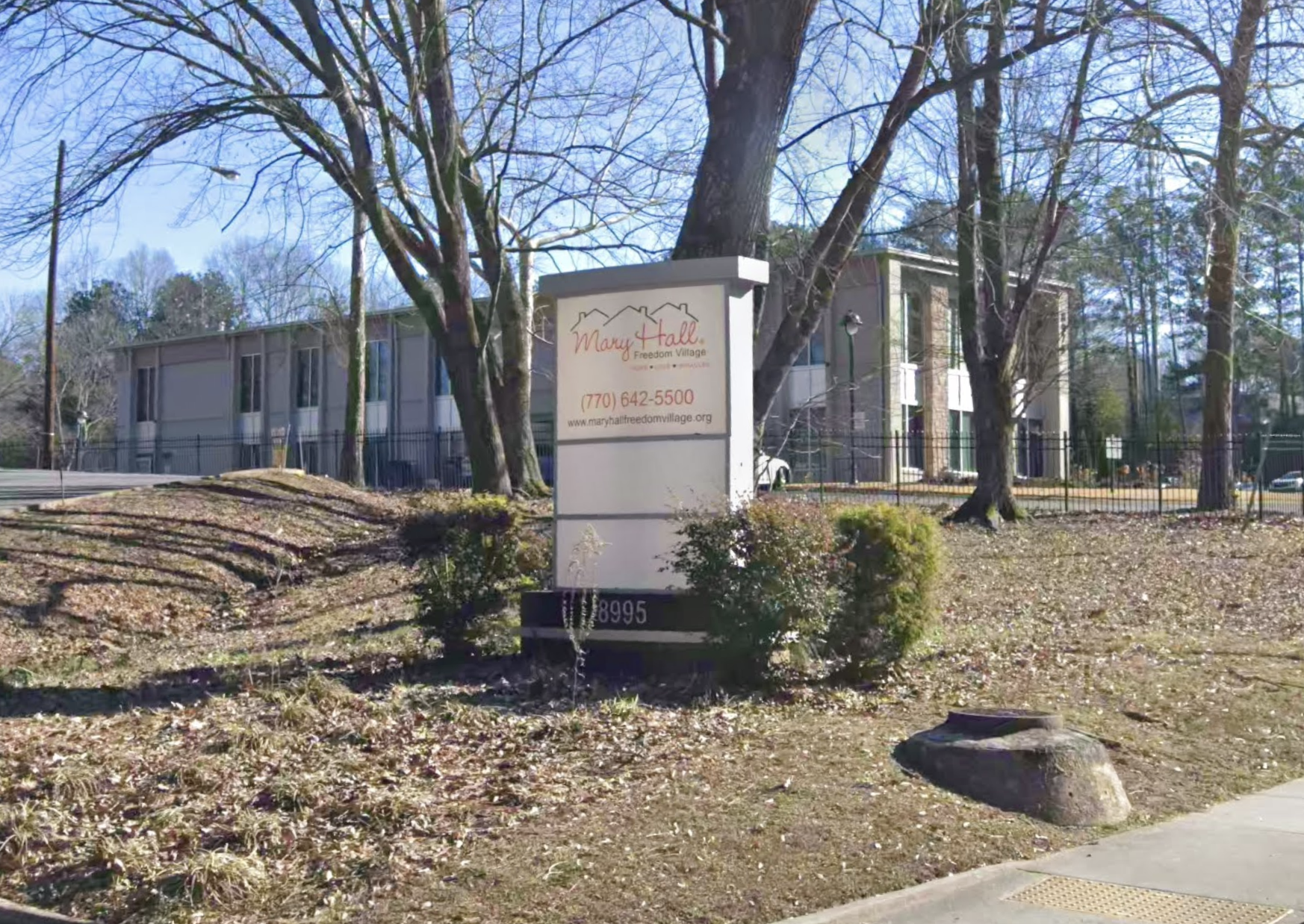 Mary Hall Freedom House sign near trees and building exterior