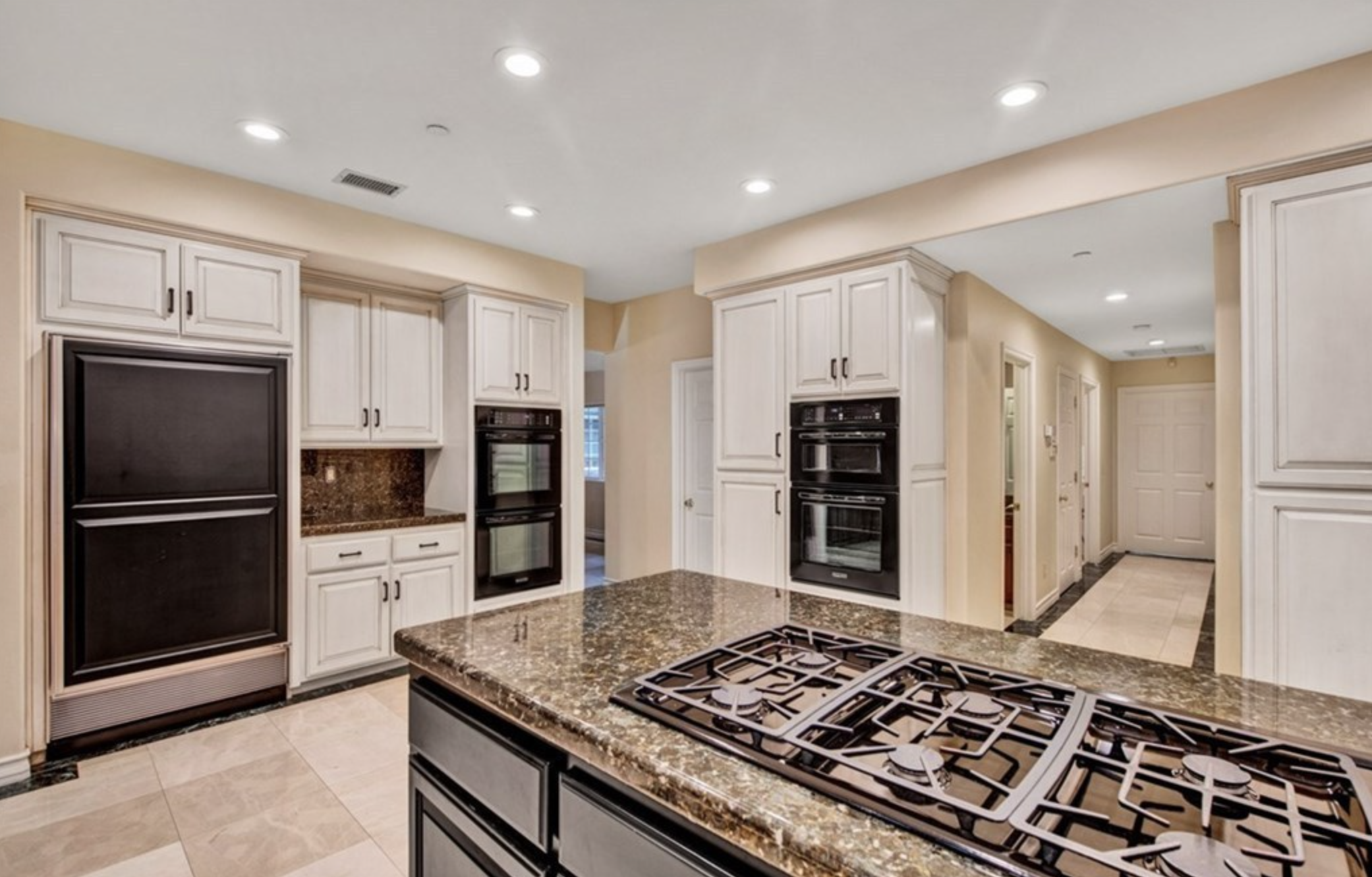 Kitchen with center island stove.
