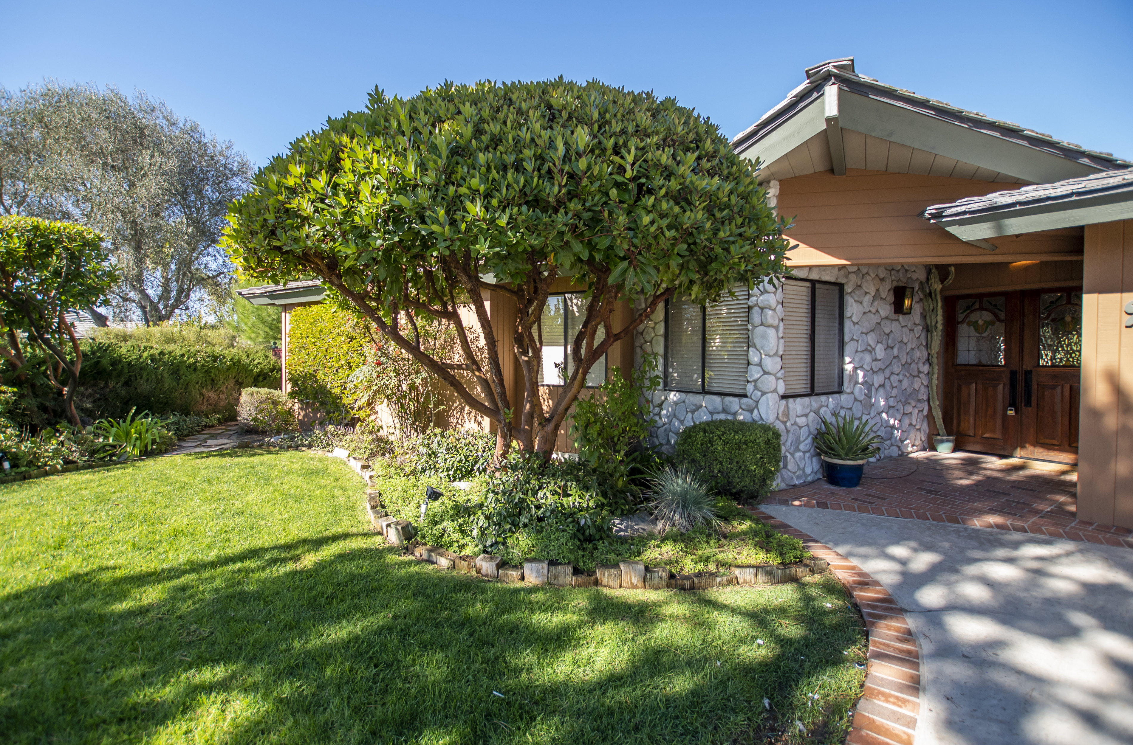 A welcoming rehab facility exterior with lush landscaping.