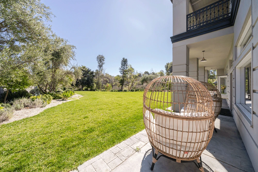 Patio chairs overlooking the green backyard