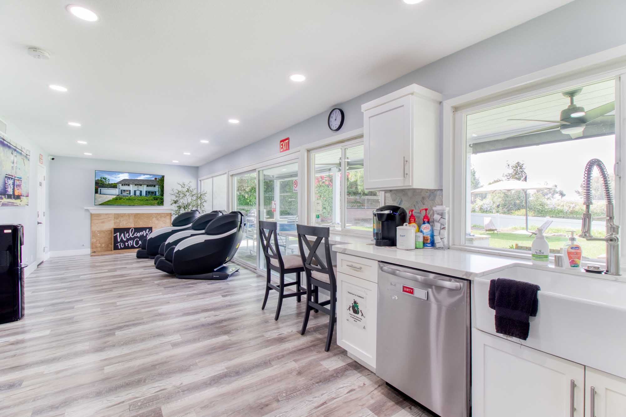 Bright lounge with bar counter, massage chairs, and large windows