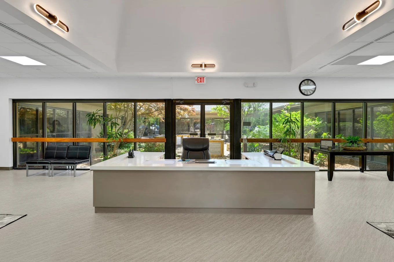 Front desk area with windows overlooking landscaped courtyard