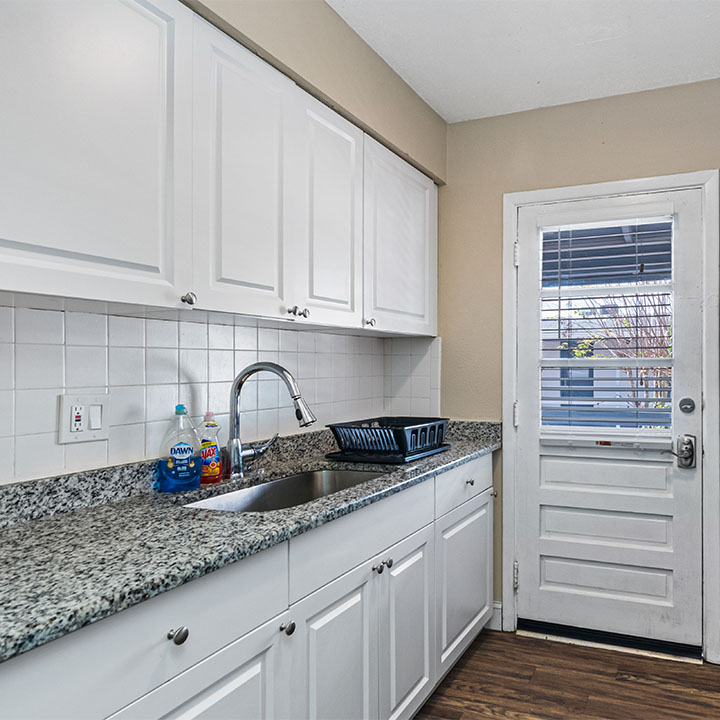Kitchen with countertops next to entrance.