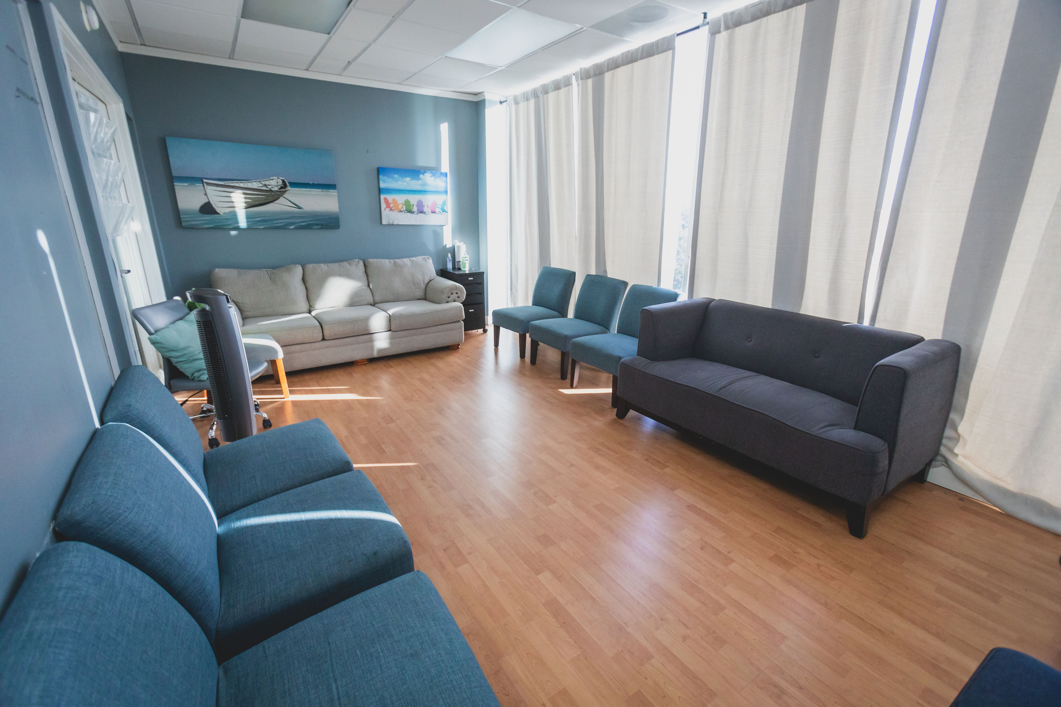 Lounge with seating and large windows.