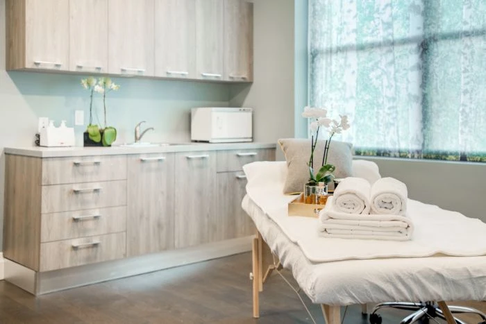 Massage bed with towels and orchid decor