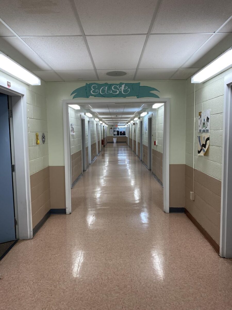 Long hallway with doors and overhead lights in rehab center
