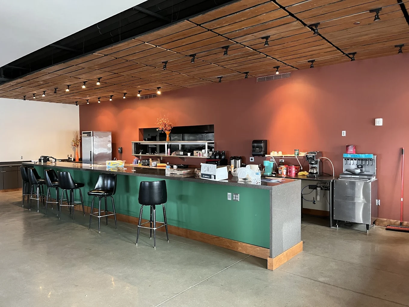 Large kitchen counter with stools and modern appliances