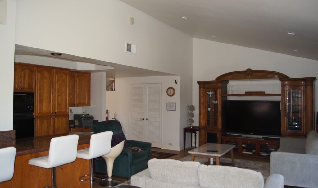 Living room with TV, couches, and bar seating