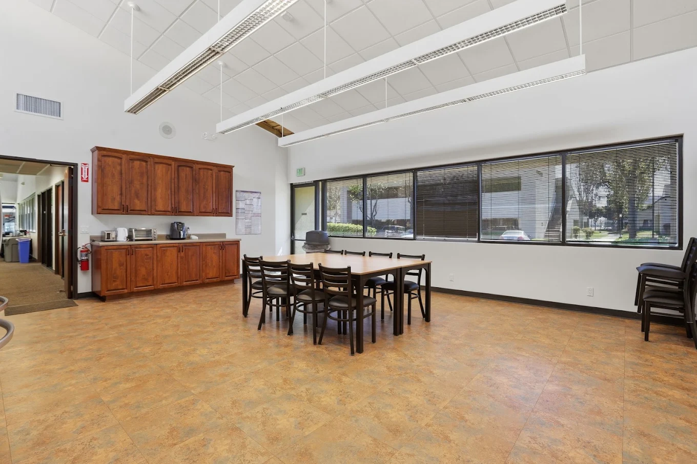 Dining area with group table, chairs, and kitchenette