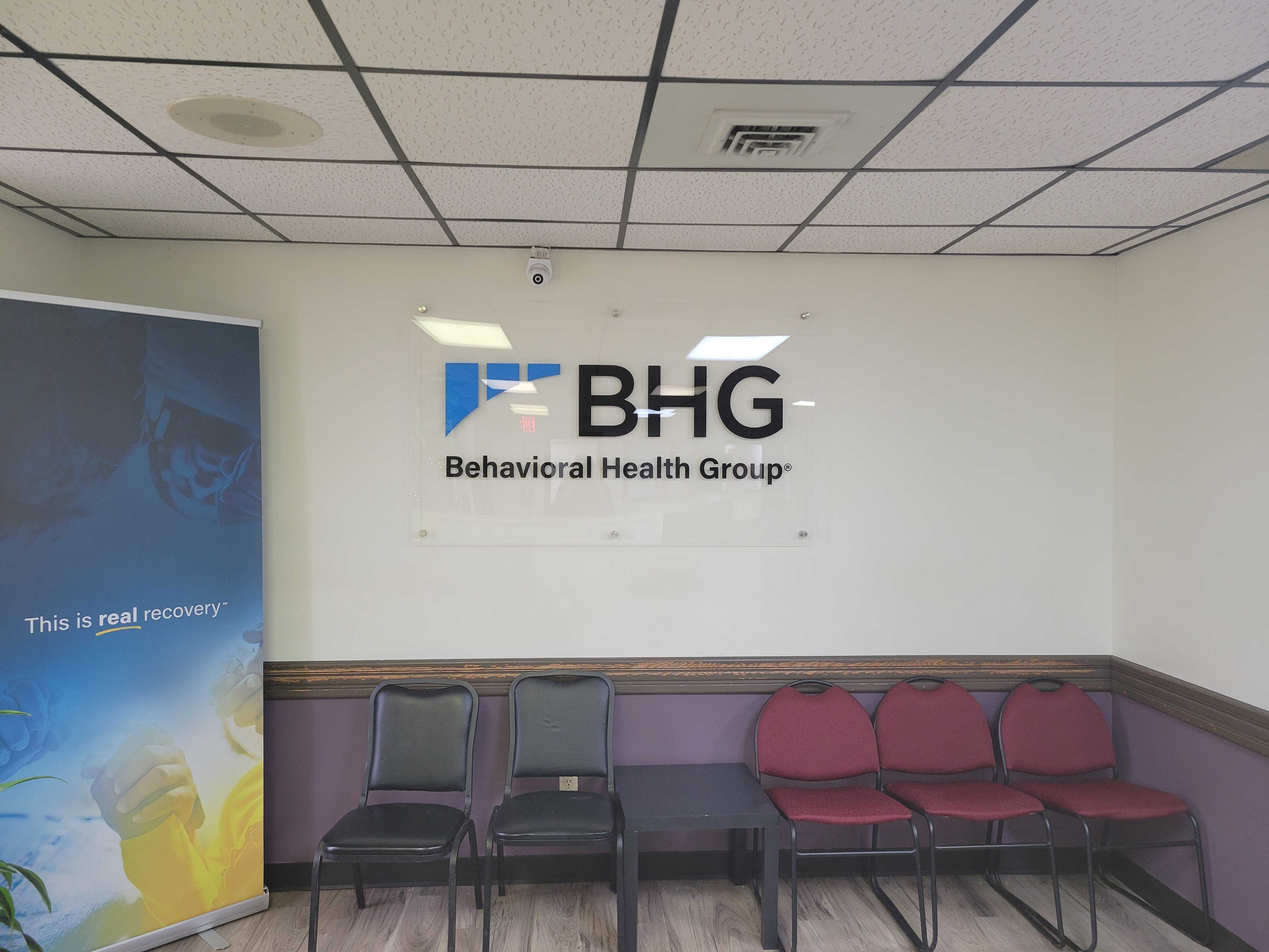 Lobby waiting area with BHG wall sign and seating