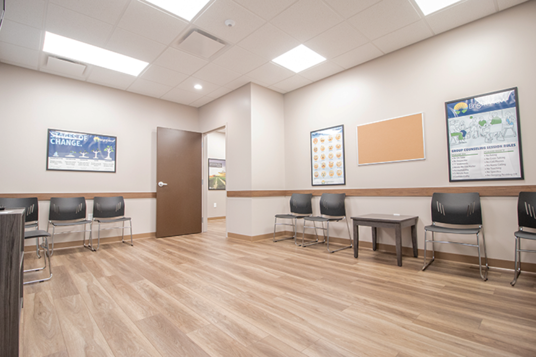 Waiting room with chairs along both walls and television