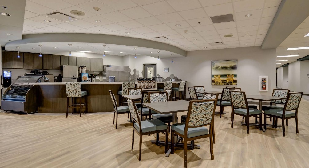 Café and dining area with tables, chairs, and coffee bar