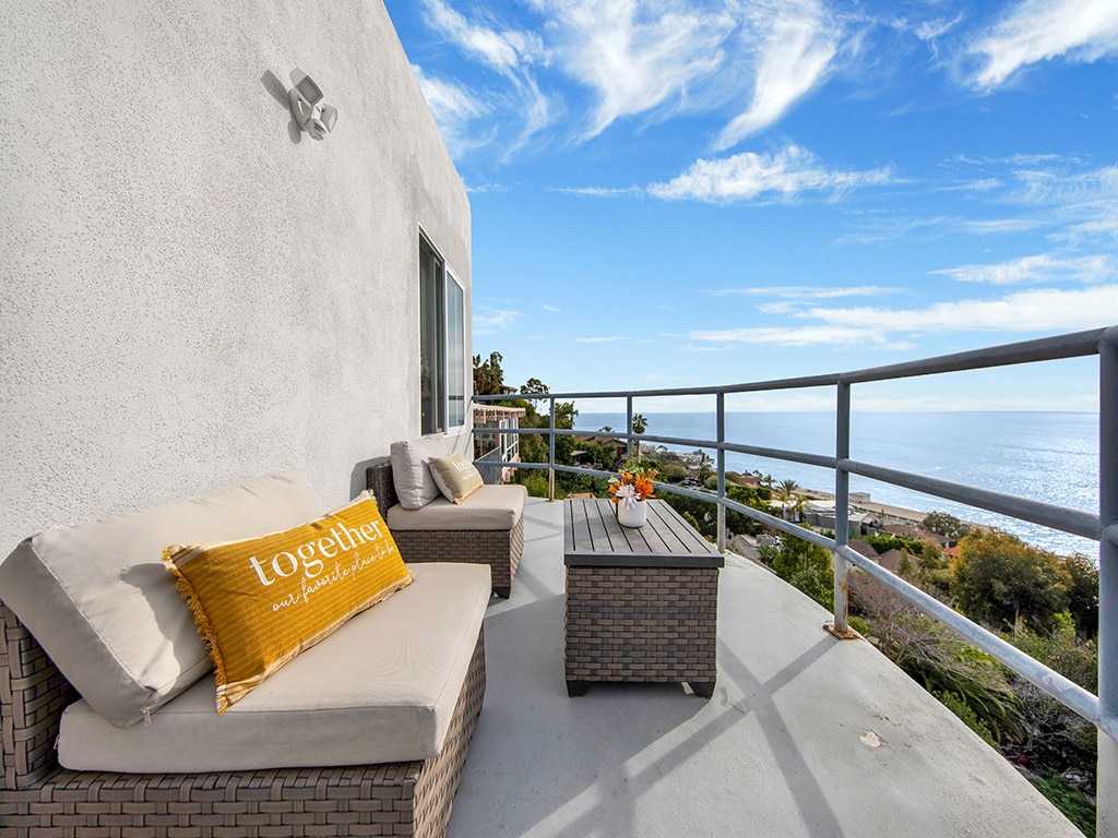 Balcony seating with ocean view and “together” pillow
