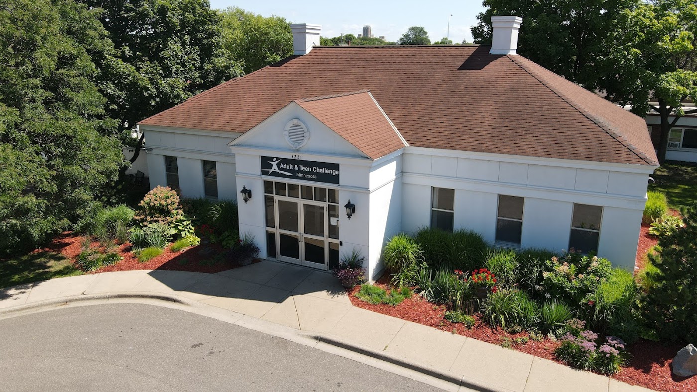White rehab facility exterior with landscaped entrance