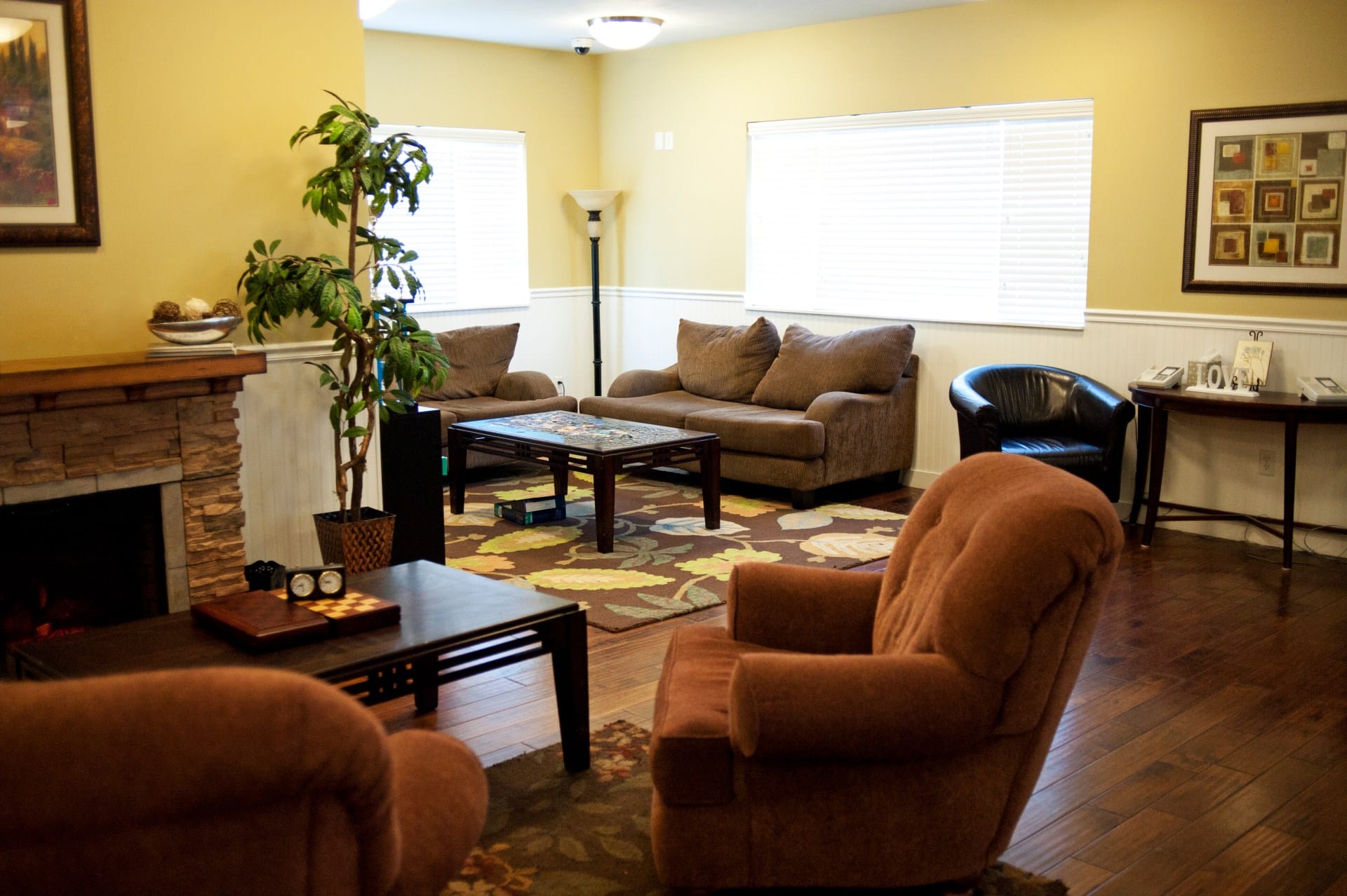 Warm-toned lounge with couches, coffee table, and rug