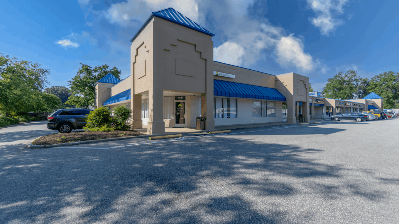 BrightView Newport News exterior with blue awnings and parking lot