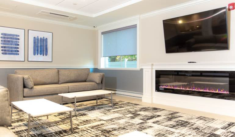 Comfortable lounge area with sofas, coffee table, and TV.