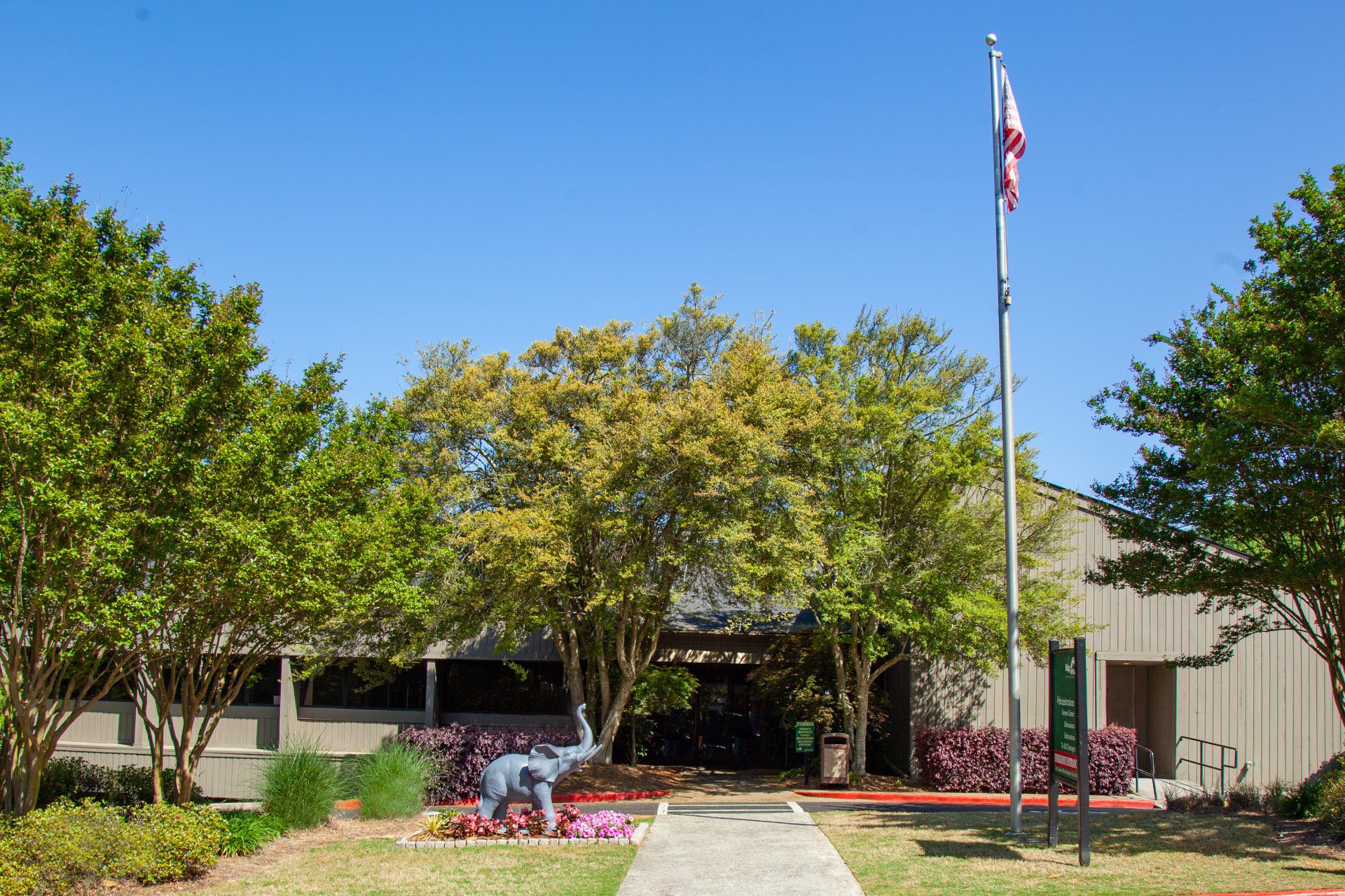 Tree-lined entrance with landscaped garden and walkway