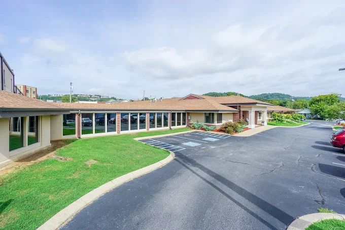 Front exterior of CADAS facility with parking area and lawn
