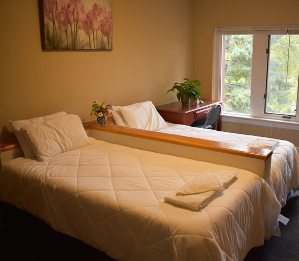 Bedroom with two beds and window desk