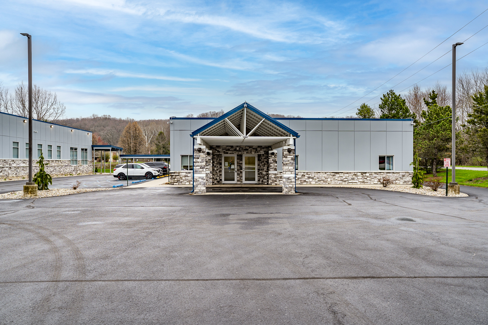Covered facility entrance with driveway view