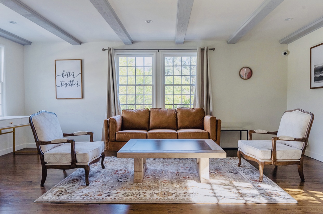 Seating area with a sofa and armchairs.