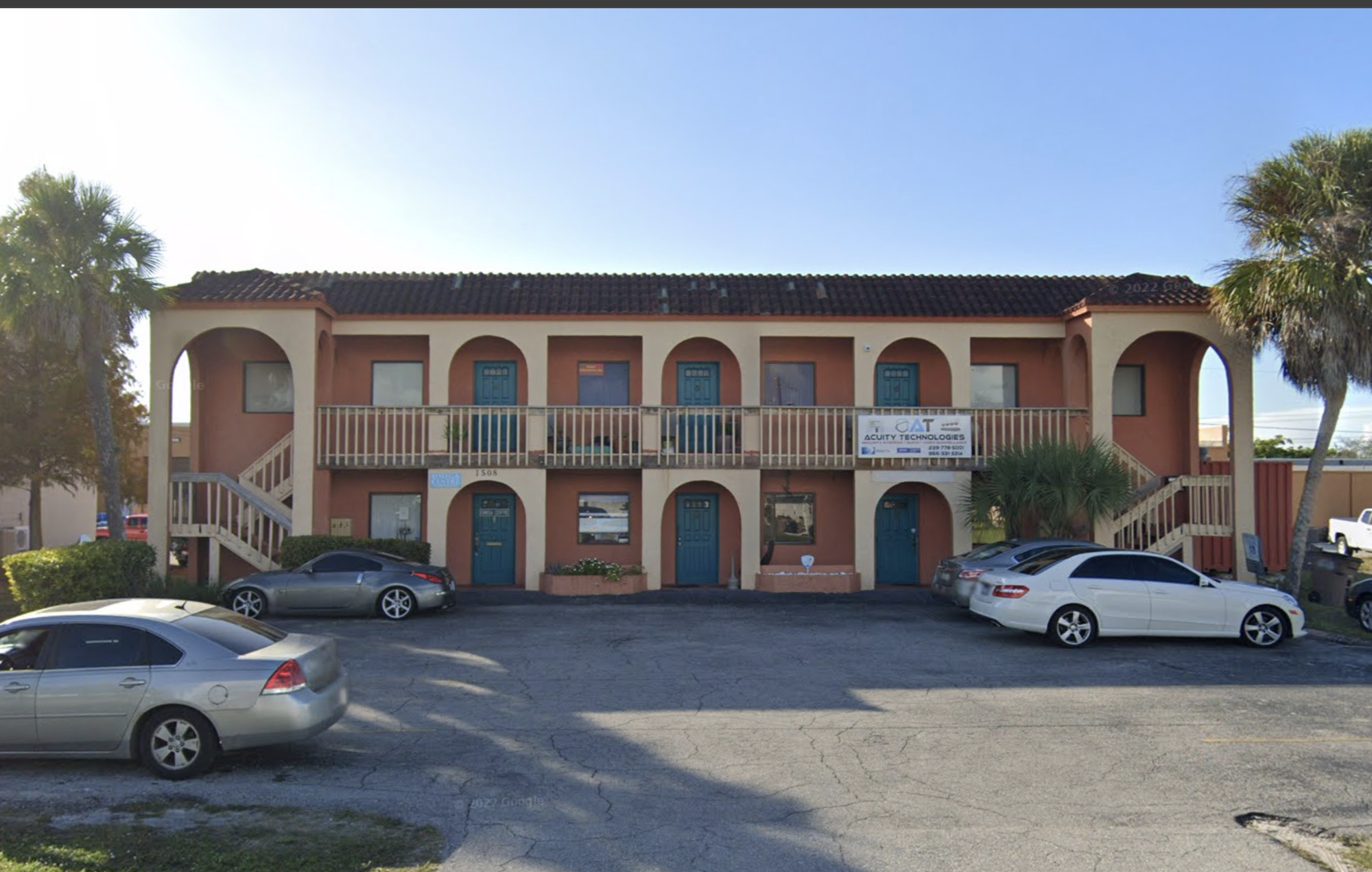 A Mediterranean-style office building with arched doorways and a warm, inviting color palette, reflecting a calm and professional setting.