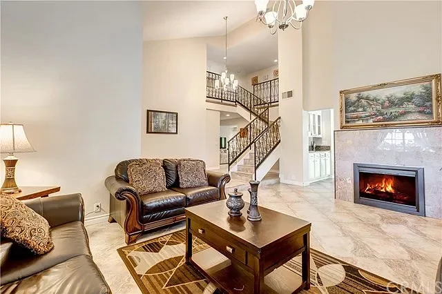 Bright lounge with gray sofas, TV, and garden view windows