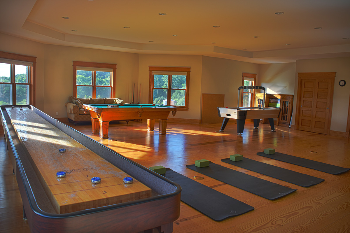 Recreation room with shuffleboard, pool table, and yoga mats