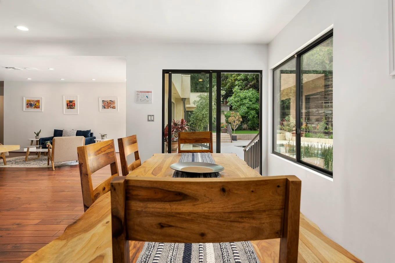 Wood dining table near large windows and outdoor access
