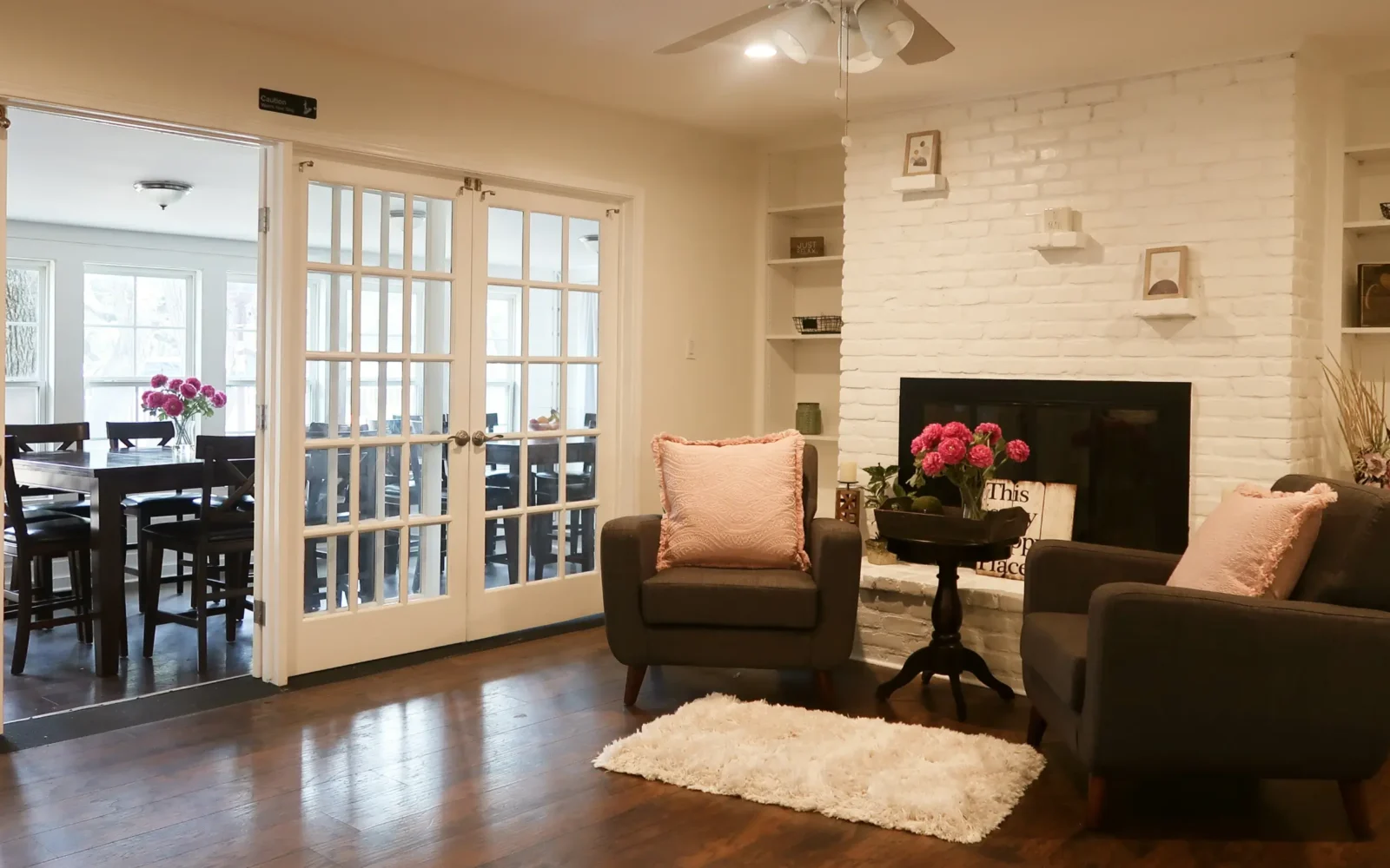 Bright dining room with tables and pink flower centerpieces