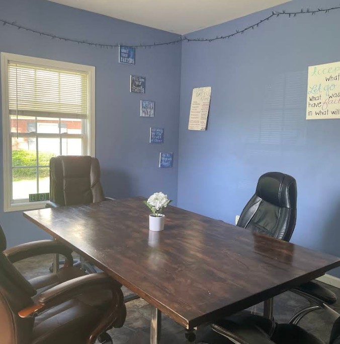 Group therapy room with conference table and chairs
