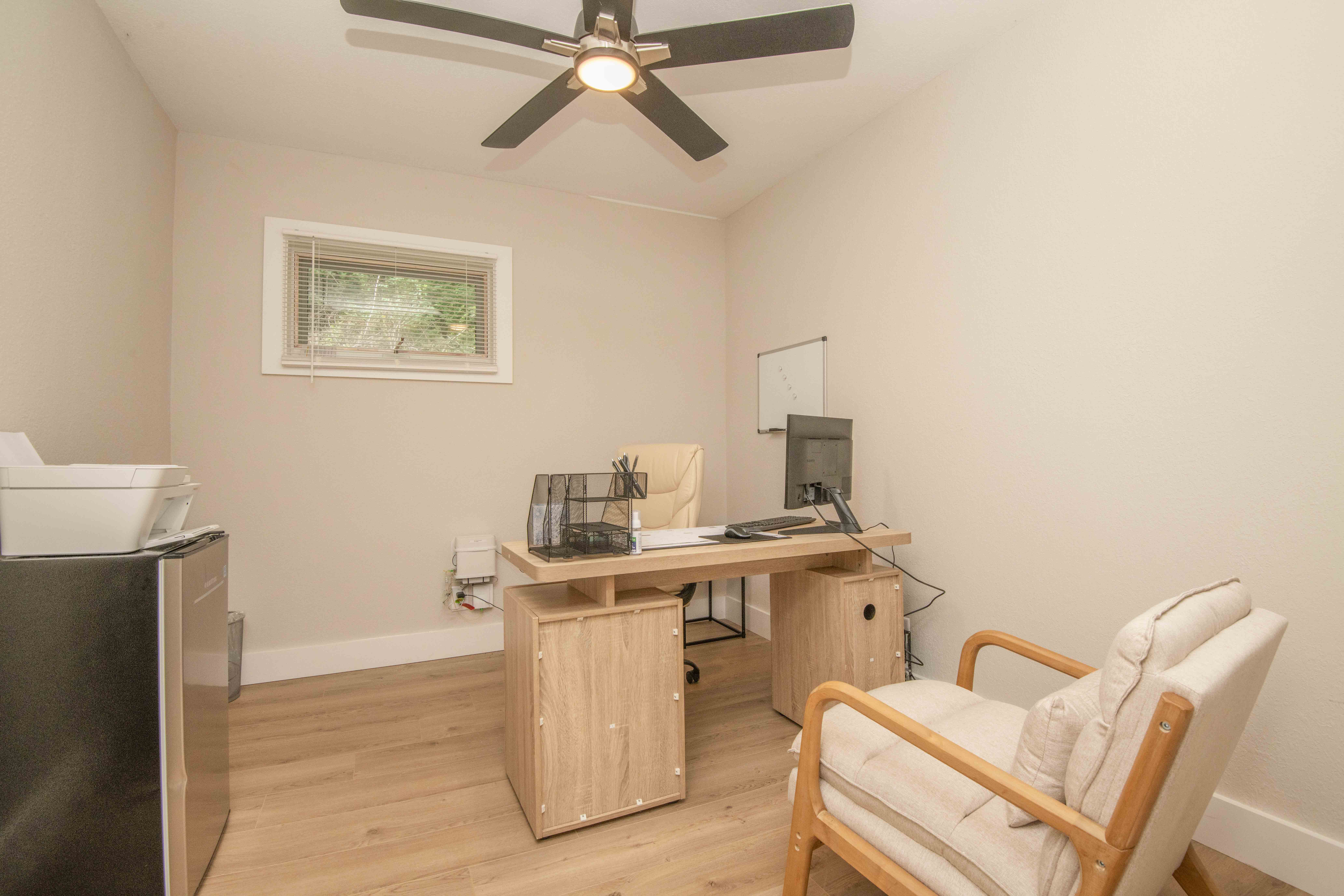  Office with desk, chair, and small fridge