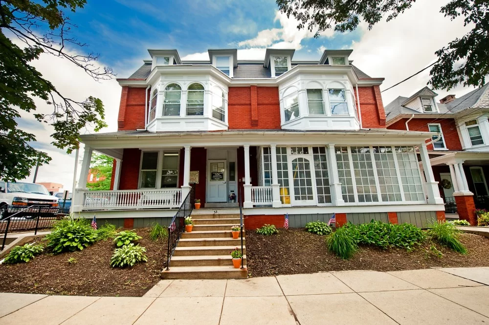Brick rehab facility with white trim and front steps