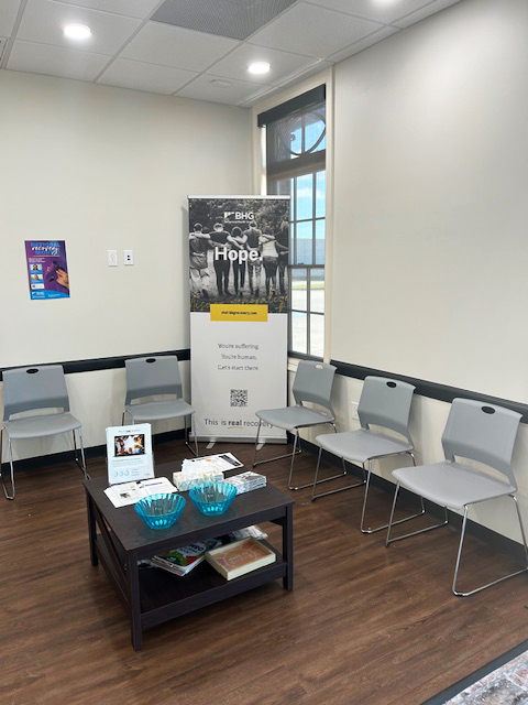 Lobby seating area with chairs, table, and recovery resources